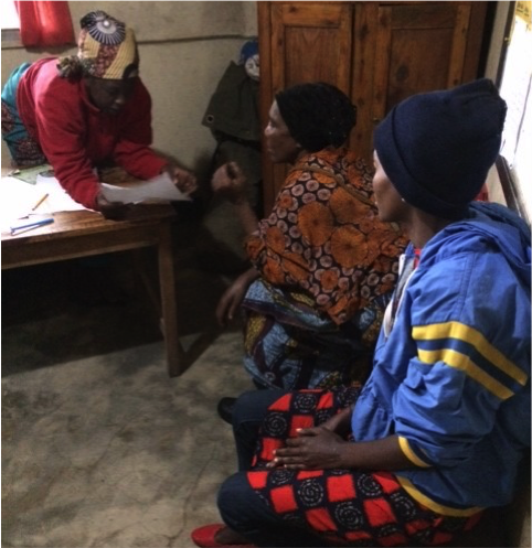 Mothers meet with one of the teachers to review homework. Courtesy of Letipis Ole Supeet