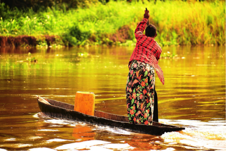 Women trading good via river. Credit-