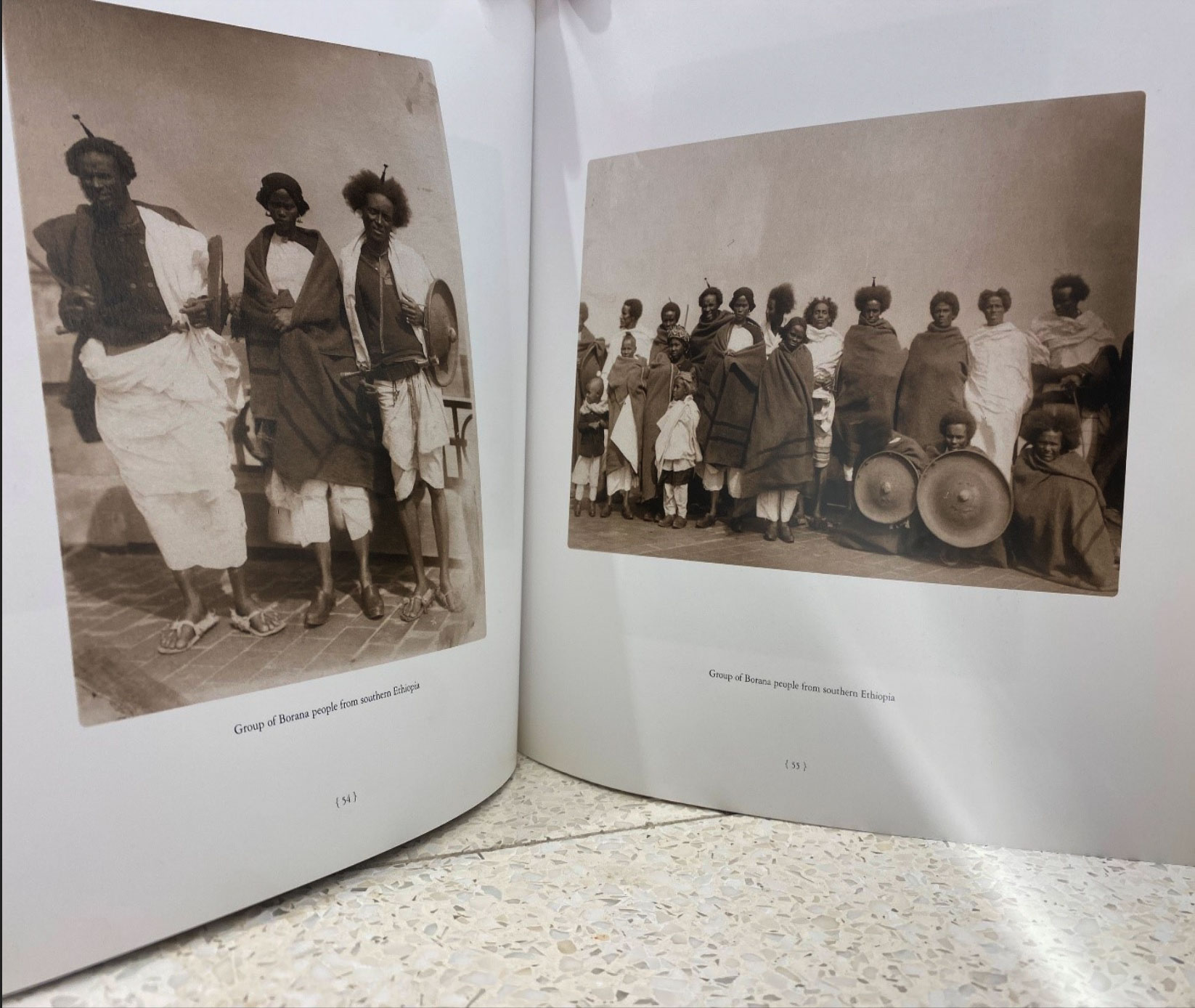Figure 3. Borana People of Southern Ethiopia, photograph by Augustus F. Sherman. In Ellis Island Portraits, 1905–1920 (Washington, D.C.: U.S. National Archives, 2005), 54–55. Courtesy of the U.S. National Archives. Photograph of the book pages by Sora Halake from a copy held at the Martin Luther King Jr. Memorial Library, Washington, D.C.